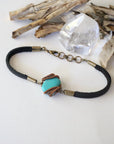 Left side view of raw turquoise bracelet showing natural stone variations and genuine leather strap, handcrafted wire wrapped jewelry