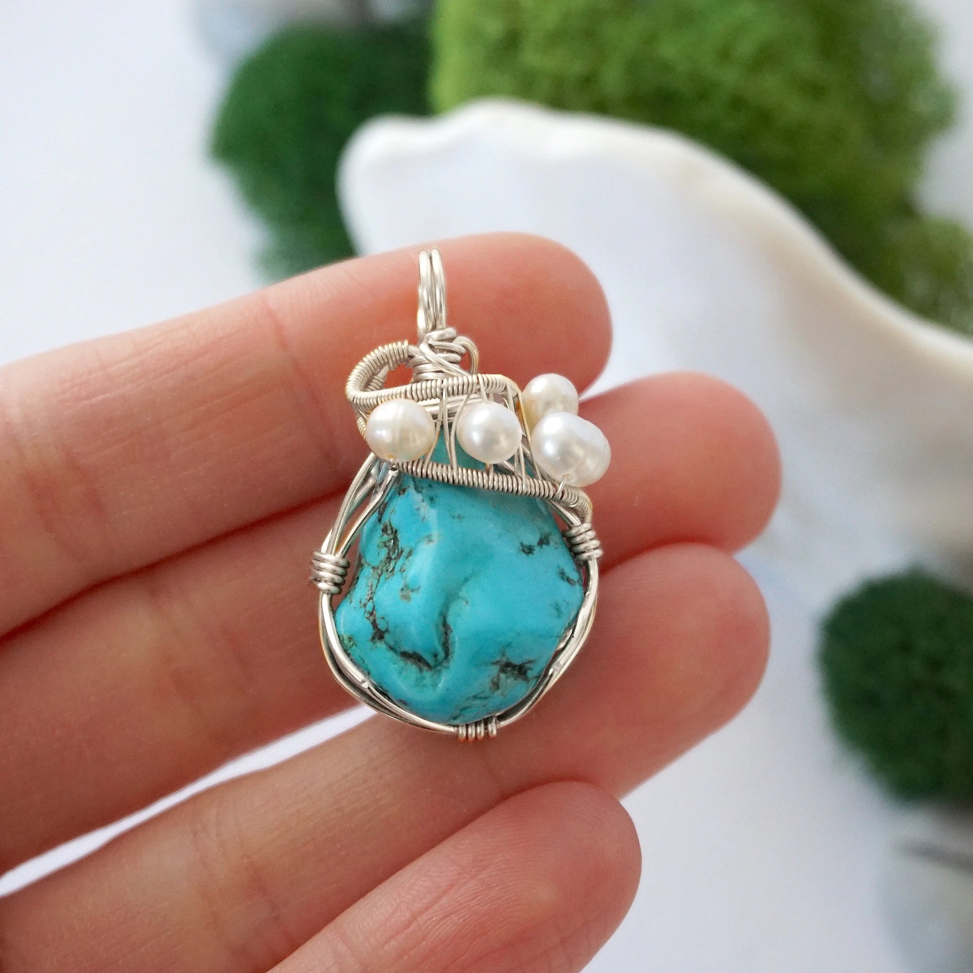 Turquoise and freshwater pearl pendant necklace in hand for size reference, silver wire wrapped, handcrafted gemstone jewelry