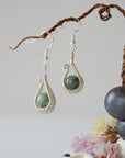 Wire wrapped emerald drop earrings in soft silver copper with natural emerald beads and handcrafted artisan design