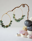 Wire wrapped emerald hoop earrings in warm gold copper with natural emerald chips and handcrafted artisan design
