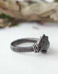 Right side band detail of wire wrapped emerald ring for men in antiqued sterling silver