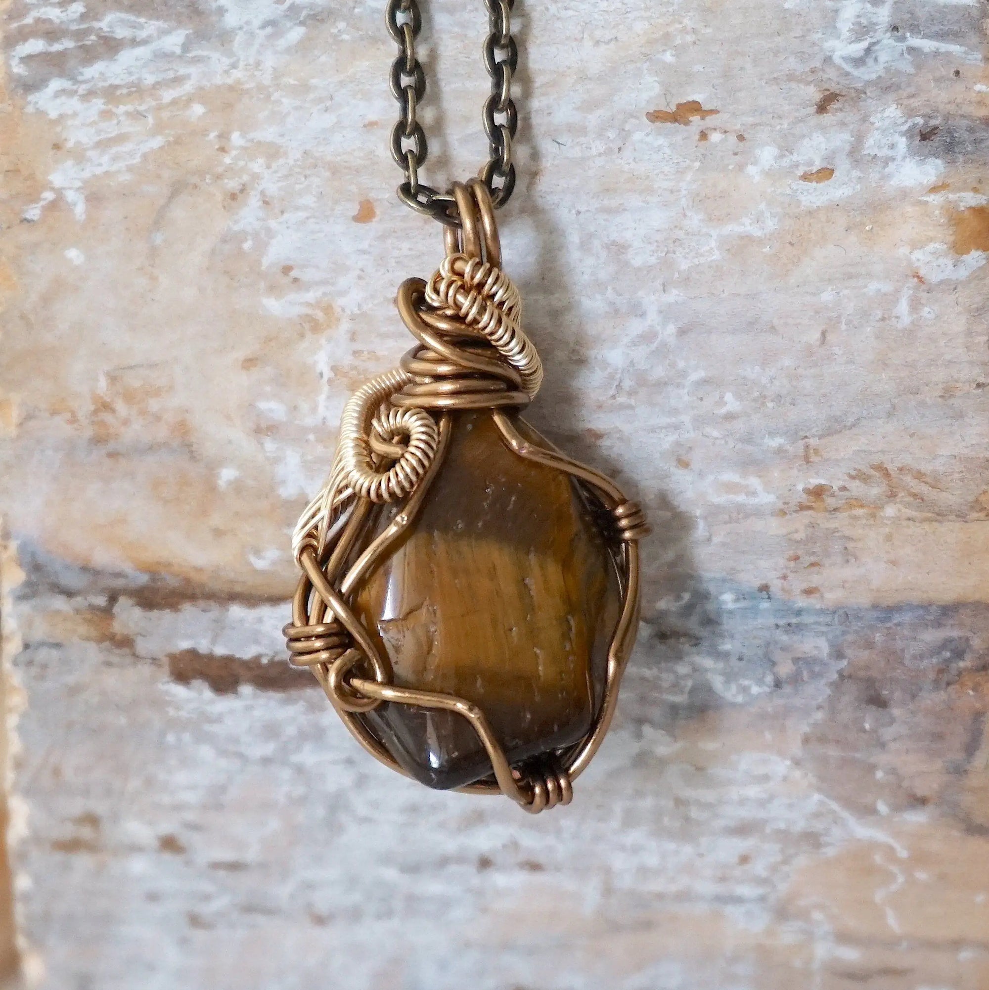 Back view of yellow tiger's eye pendant — bronze and gold wire wrapping detail, one of a kind handmade crystal pendant