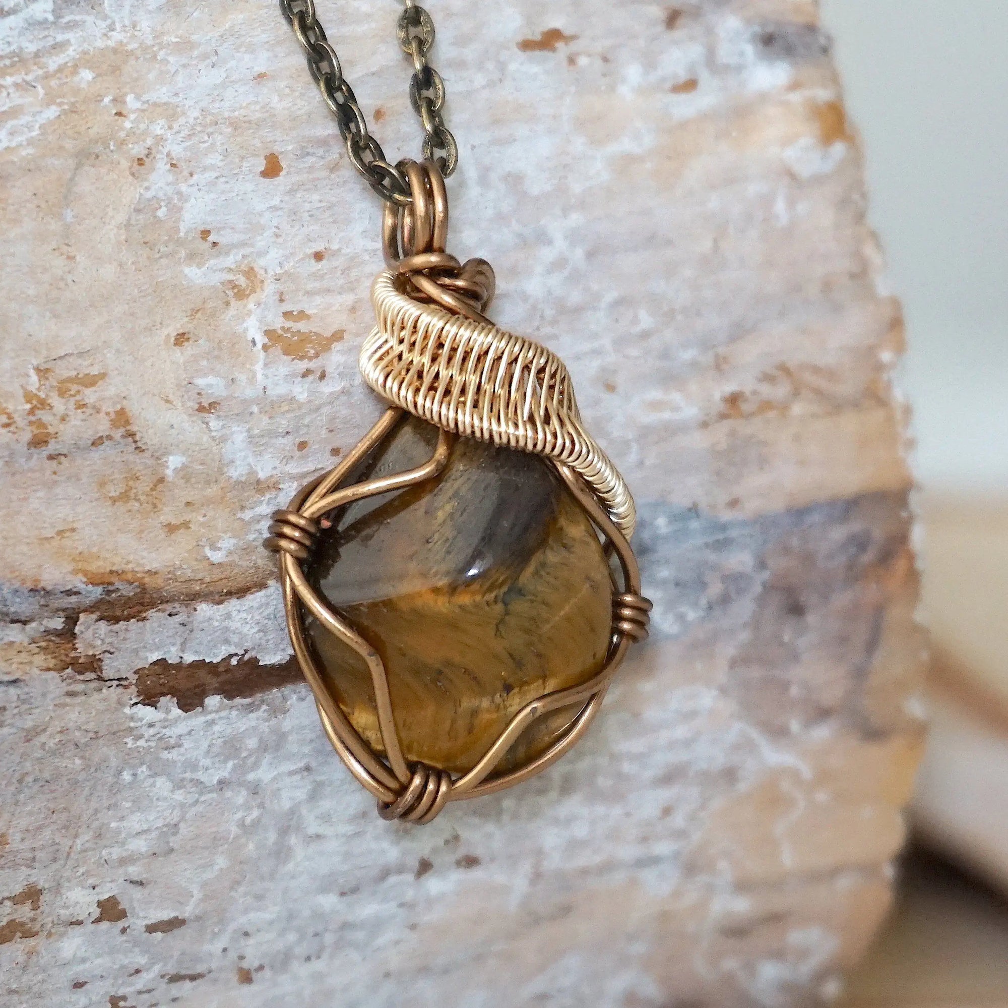 Right side view of yellow tiger's eye pendant — bronze and gold wire wrapping detail, handmade Gemini zodiac crystal necklace