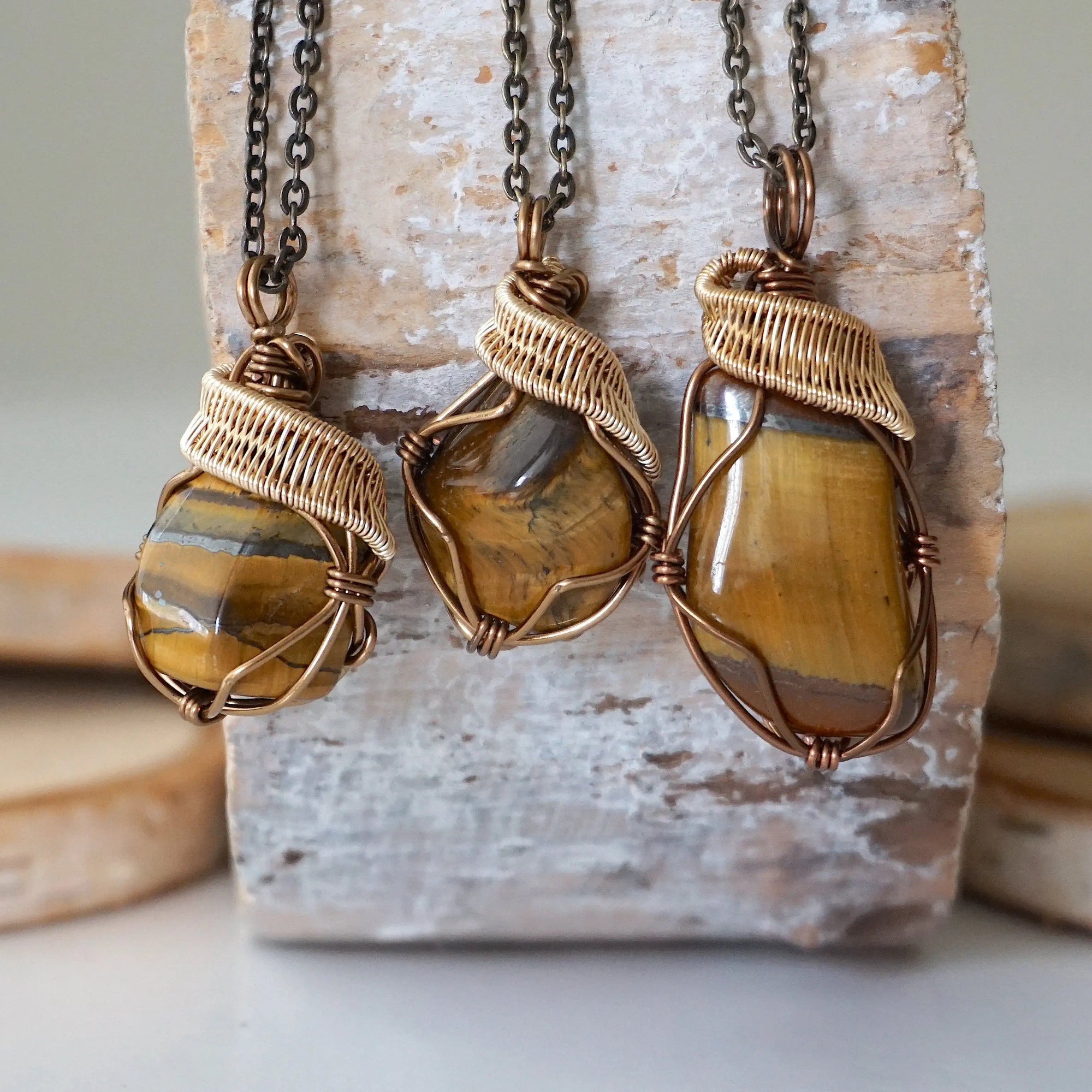 Three yellow tiger's eye pendants showing stone variation in size, shape, and colour — select your own pendant, one of a kind