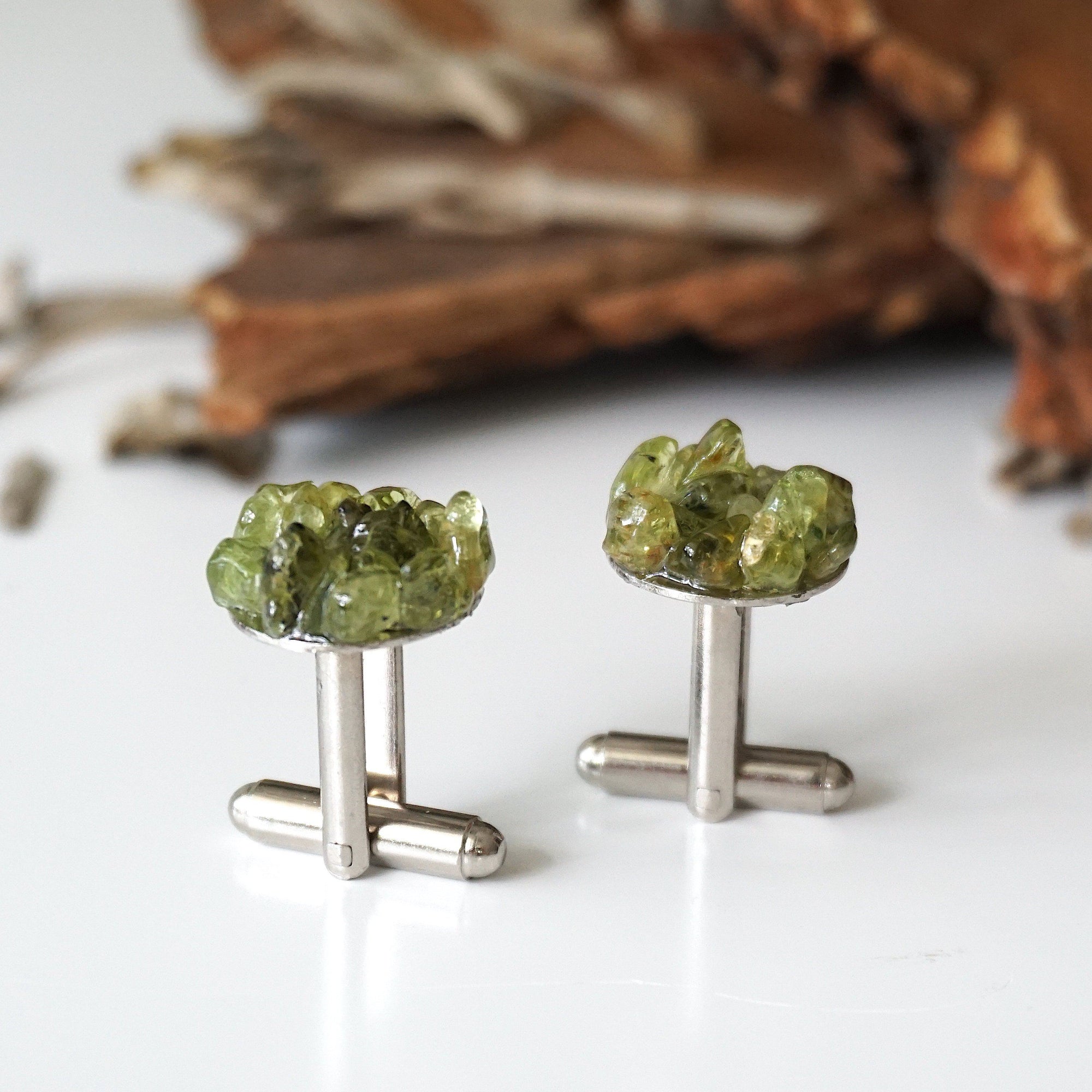 Detail angle of peridot cufflinks for men — multiple genuine raw peridot stones clustered on white gold finish face, handcrafted August birthstone crystal cufflinks
