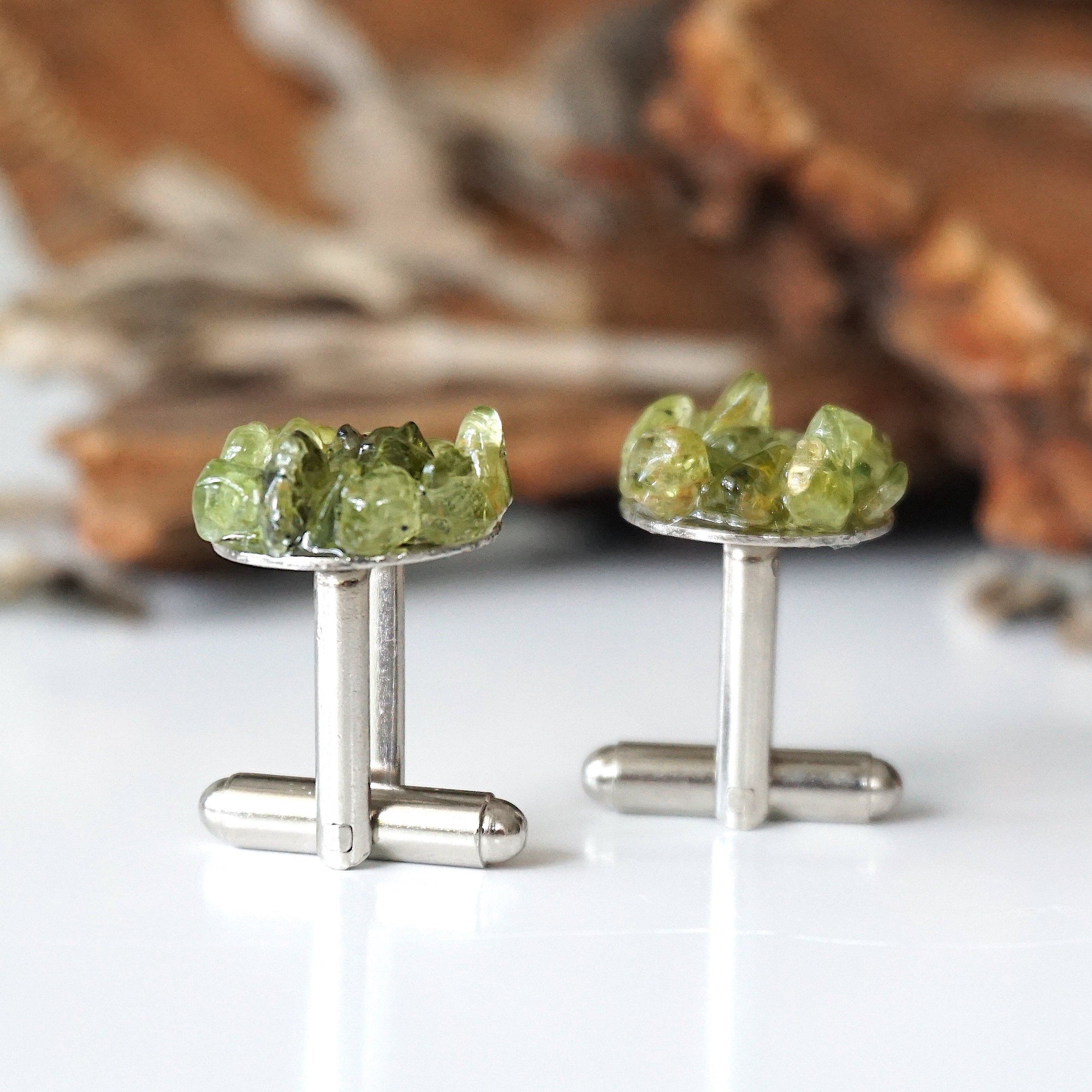 Side angle of peridot cufflinks showing T-bar toggle hardware — white gold finish over copper, genuine raw peridot cluster face, handcrafted men's August birthstone jewelry